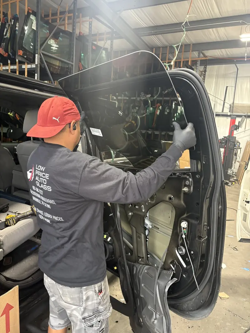 Low Price Auto Glass technician working with vehicle glass