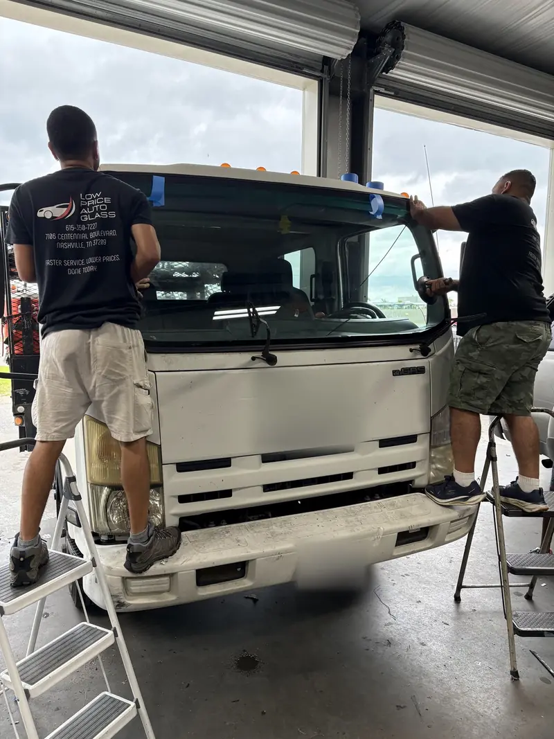 Our technicians setting a new windshield on a box truck with suction cups