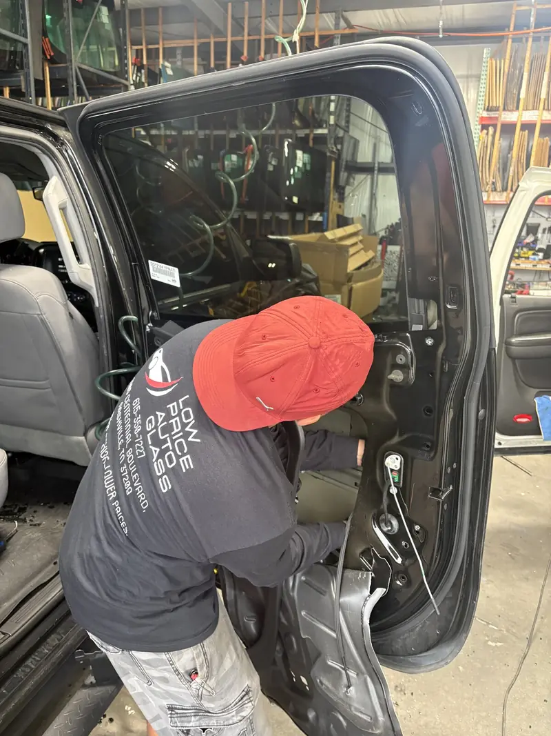 Low Price Auto Glass technician working on a vehicle