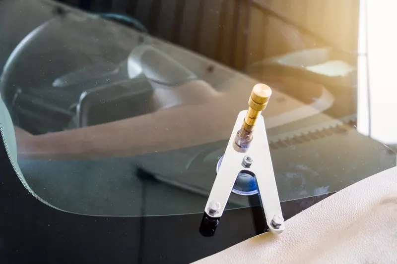Resin injection tool attached to a windshield chip